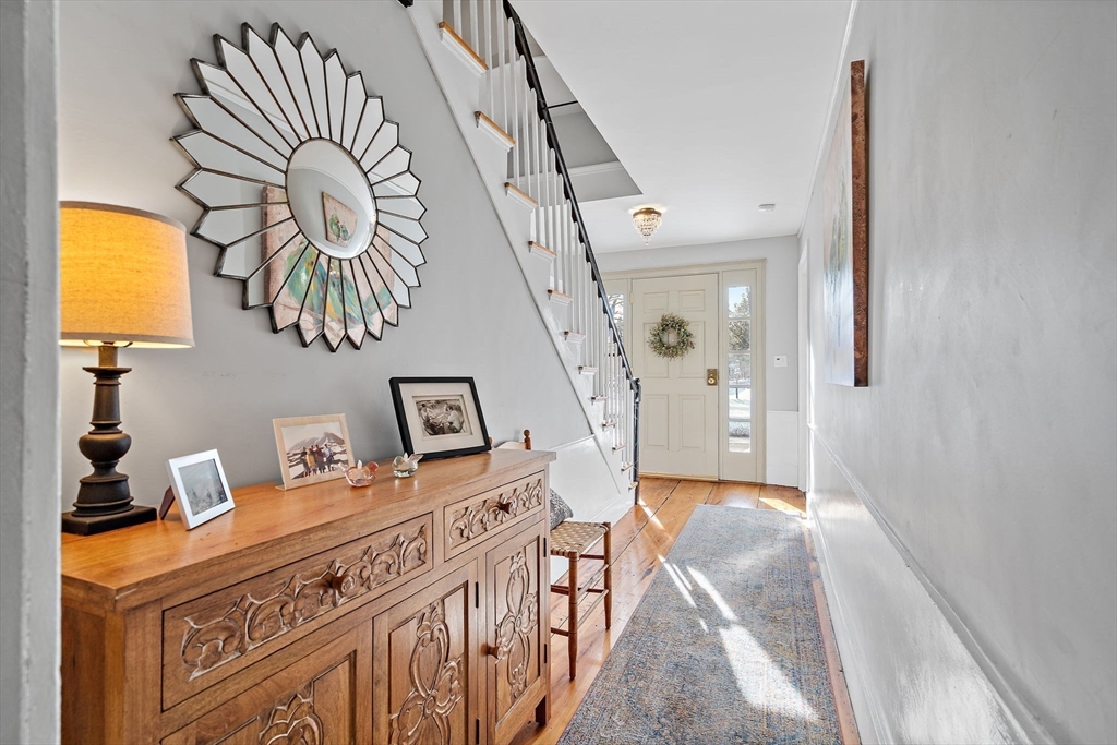 228 Main Street Groton, MA 01450 - Photo 3 of 33 a bedroom with a bed and a chandelier
