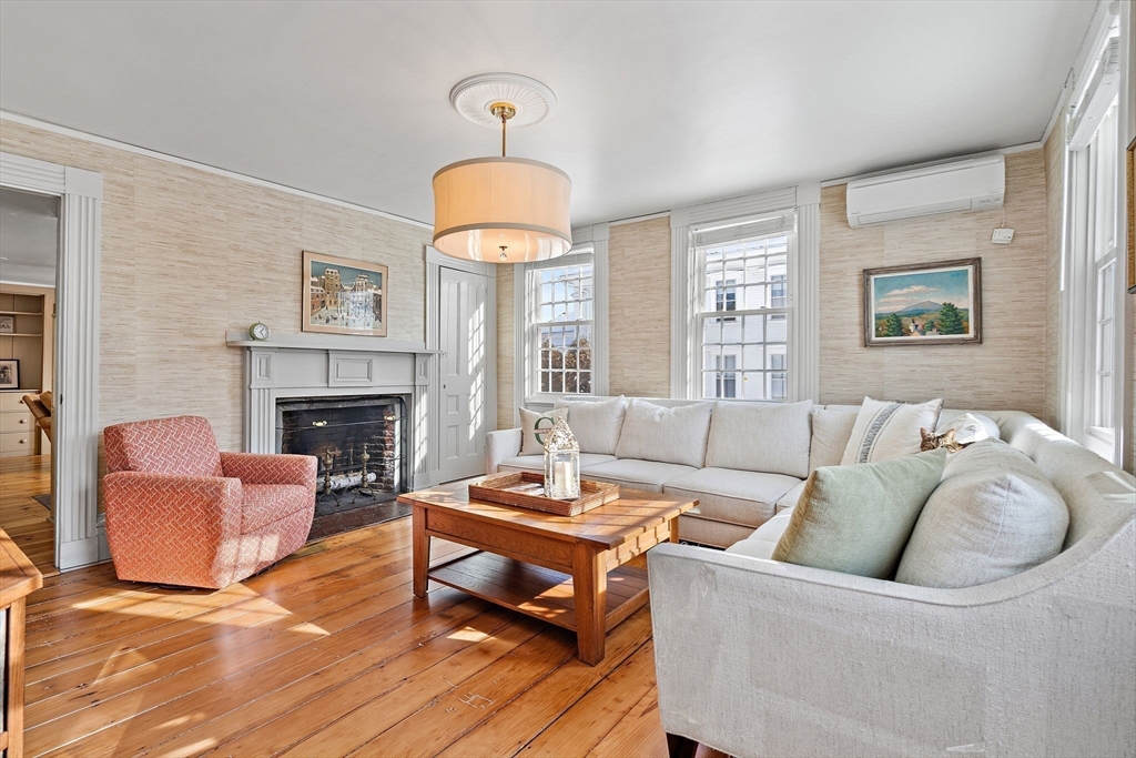 228 Main Street Groton, MA 01450 - Photo 5 of 33 a living room with furniture a fireplace and a chandelier