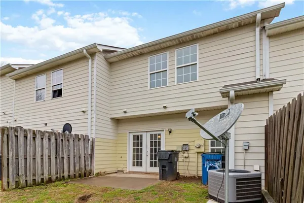 a view of a house with wooden fence