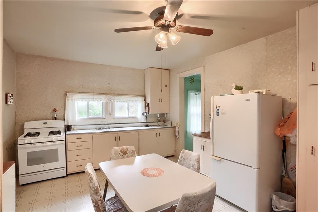 890 Old State Road Apollo, PA 15613 - Photo 12 of 25 a kitchen with a stove a refrigerator and a chandelier