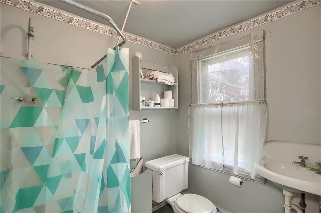 890 Old State Road Apollo, PA 15613 - Photo 22 of 25 a white toilet sitting next to a bathroom sink and tub