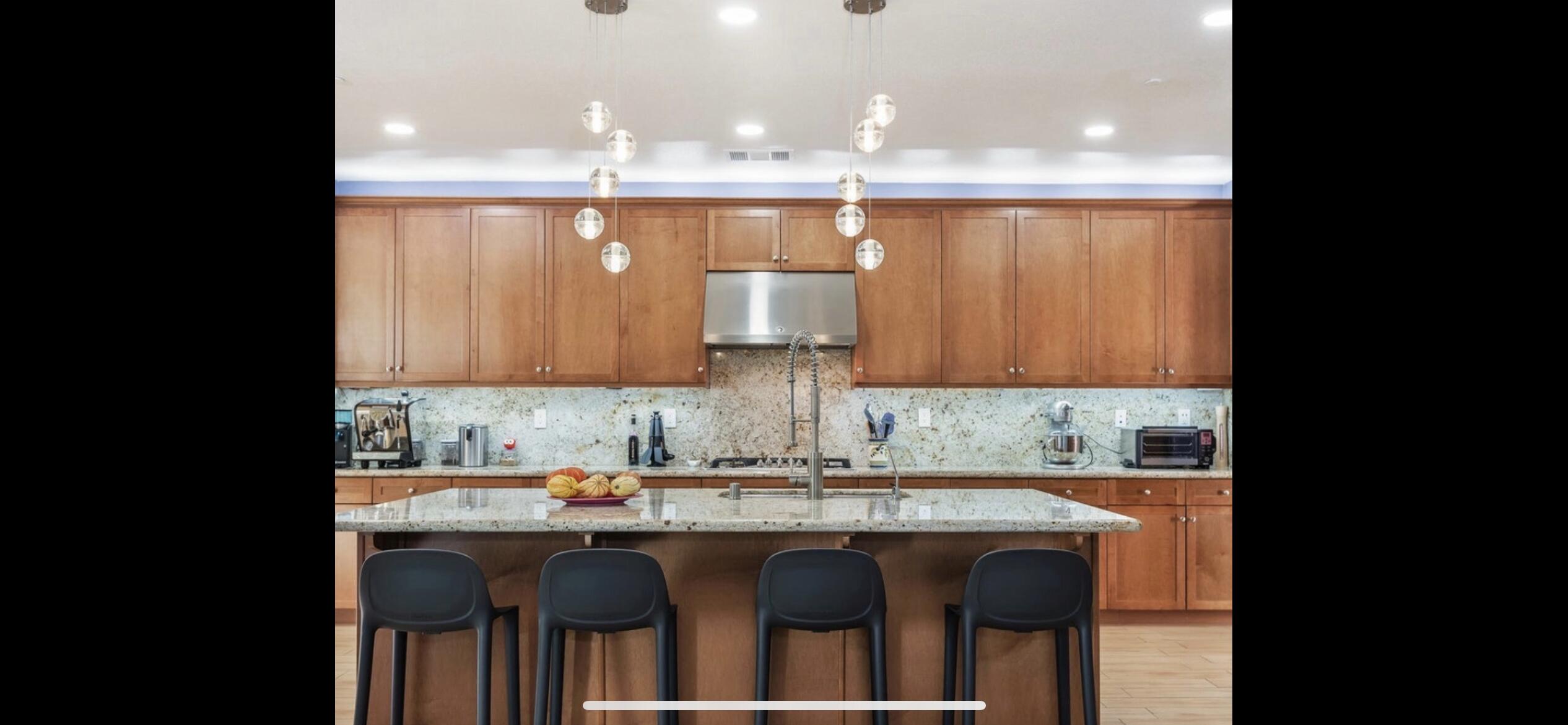 Undisclosed Address Carpinteria, CA 93013 - Photo 4 of 12 a kitchen with kitchen island granite countertop a sink and cabinets