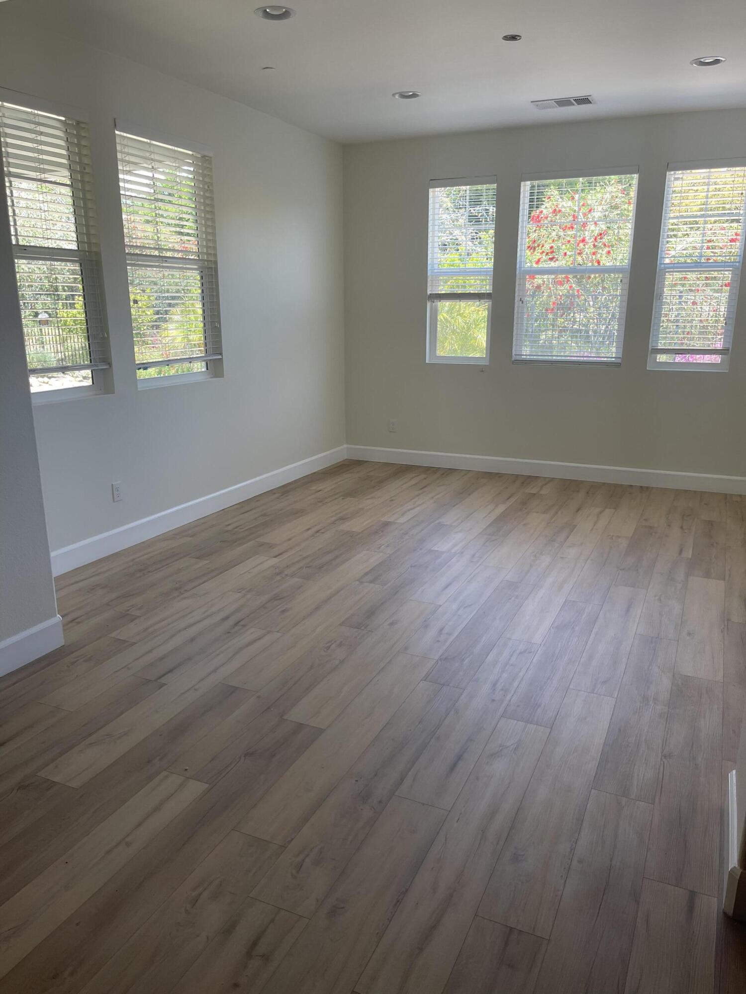Undisclosed Address Carpinteria, CA 93013 - Photo 5 of 12 an empty room with wooden floor and windows
