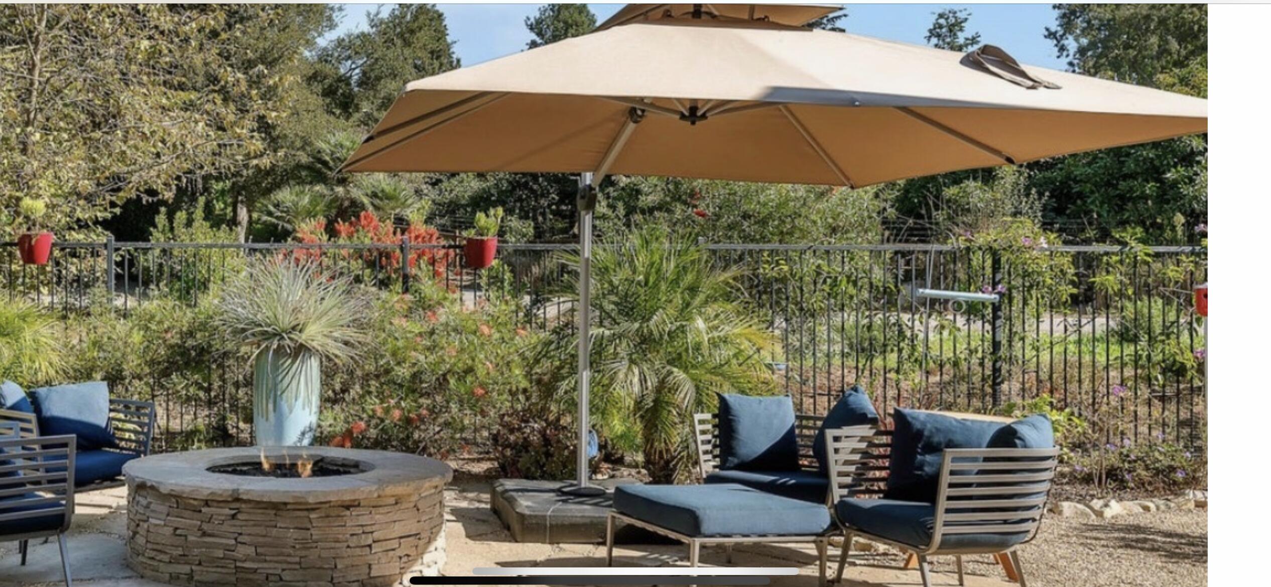 Undisclosed Address Carpinteria, CA 93013 - Photo 8 of 12 a patio with tables and chairs and a umbrella