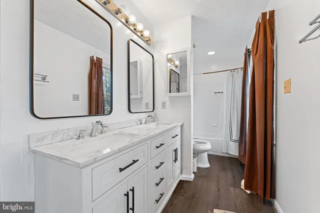 a bathroom with a double vanity sink and a mirror