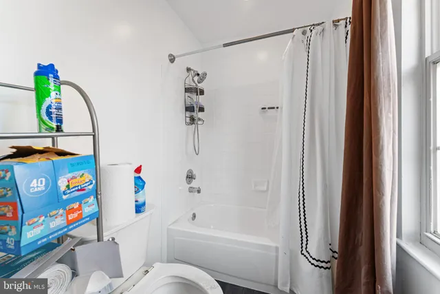 a bathroom with a bathtub and shower