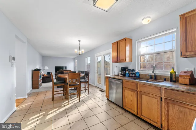 a kitchen with stainless steel appliances granite countertop sink cabinets and window