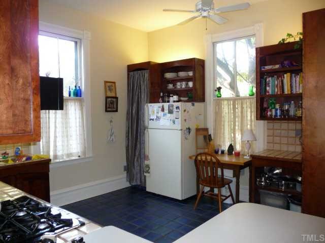 500 Polk Street Raleigh, NC 27604 - Photo 7 of 12 a kitchen with stainless steel appliances wooden floor and a refrigerator