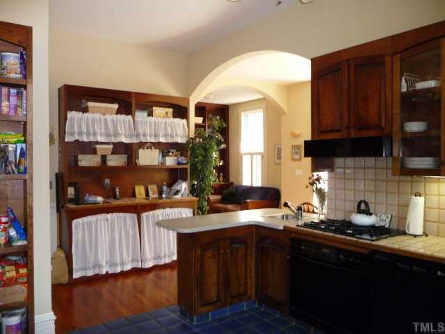 500 Polk Street Raleigh, NC 27604 - Photo 10 of 12 a kitchen with a sink dishwasher a stove and a microwave oven