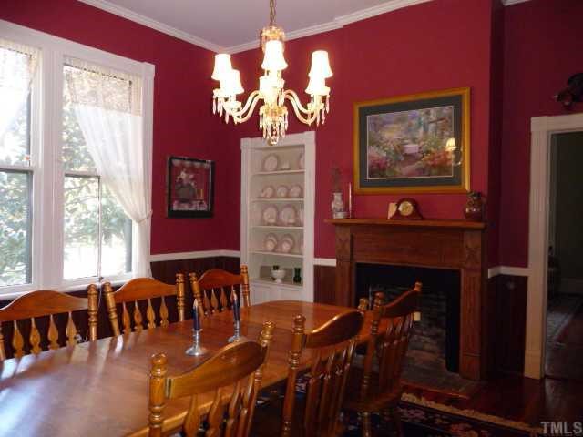 500 Polk Street Raleigh, NC 27604 - Photo 11 of 12 a view of a dining room with furniture a chandelier and wooden floor