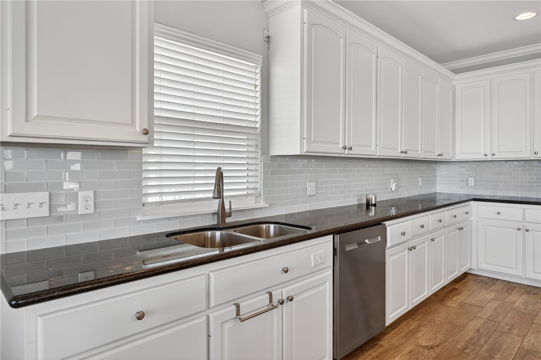 838 Rattlesnake Point Road Rockport, TX 78382 - Photo 16 of 40 a kitchen with granite countertop white cabinets and white appliances