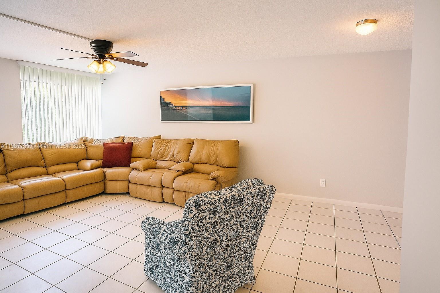 200 172nd Street, Unit 201 Sunny Isles Beach, FL 33160 - Photo 2 of 12 a living room with a couch