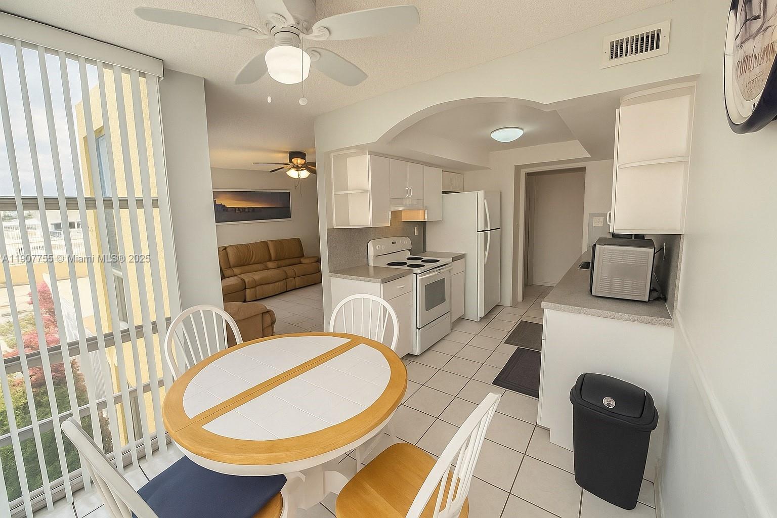 200 172nd Street, Unit 201 Sunny Isles Beach, FL 33160 - Photo 3 of 12 a kitchen with stainless steel appliances a stove a chimney a sink and a refrigerator