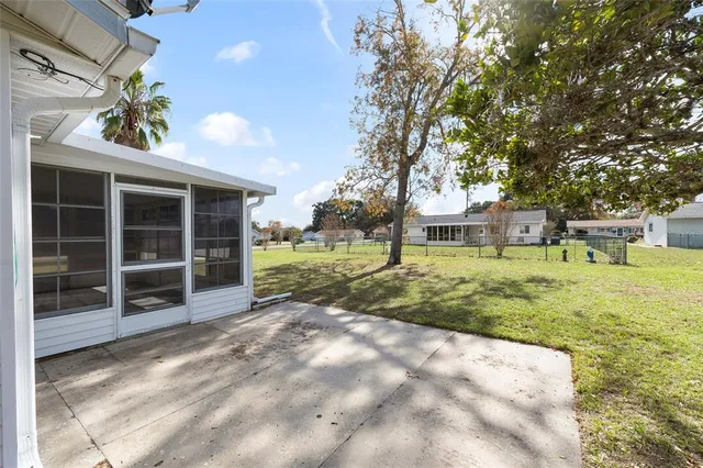 an empty room with windows and ceiling fan