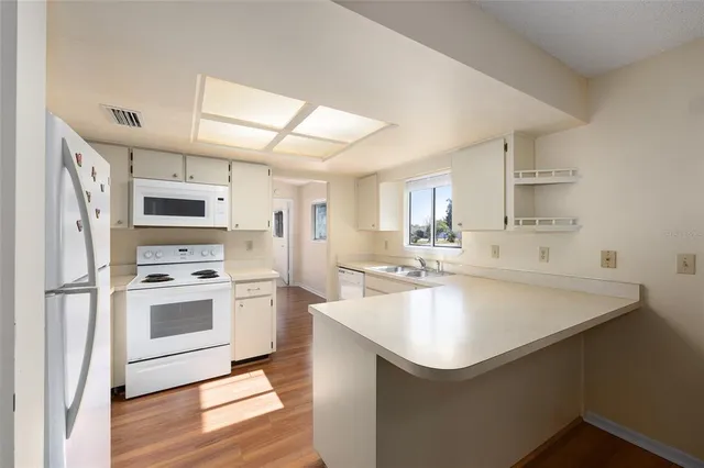 an empty room with wooden floor and window