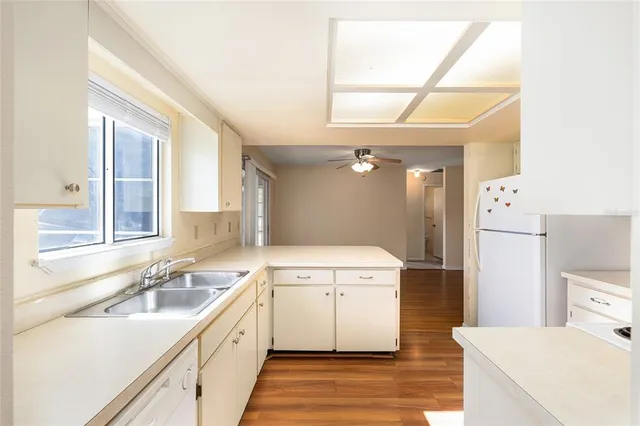 a view of a kitchen with wooden floor and a kitchen