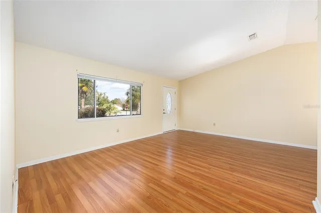 a view of a room with wooden floor and staircase