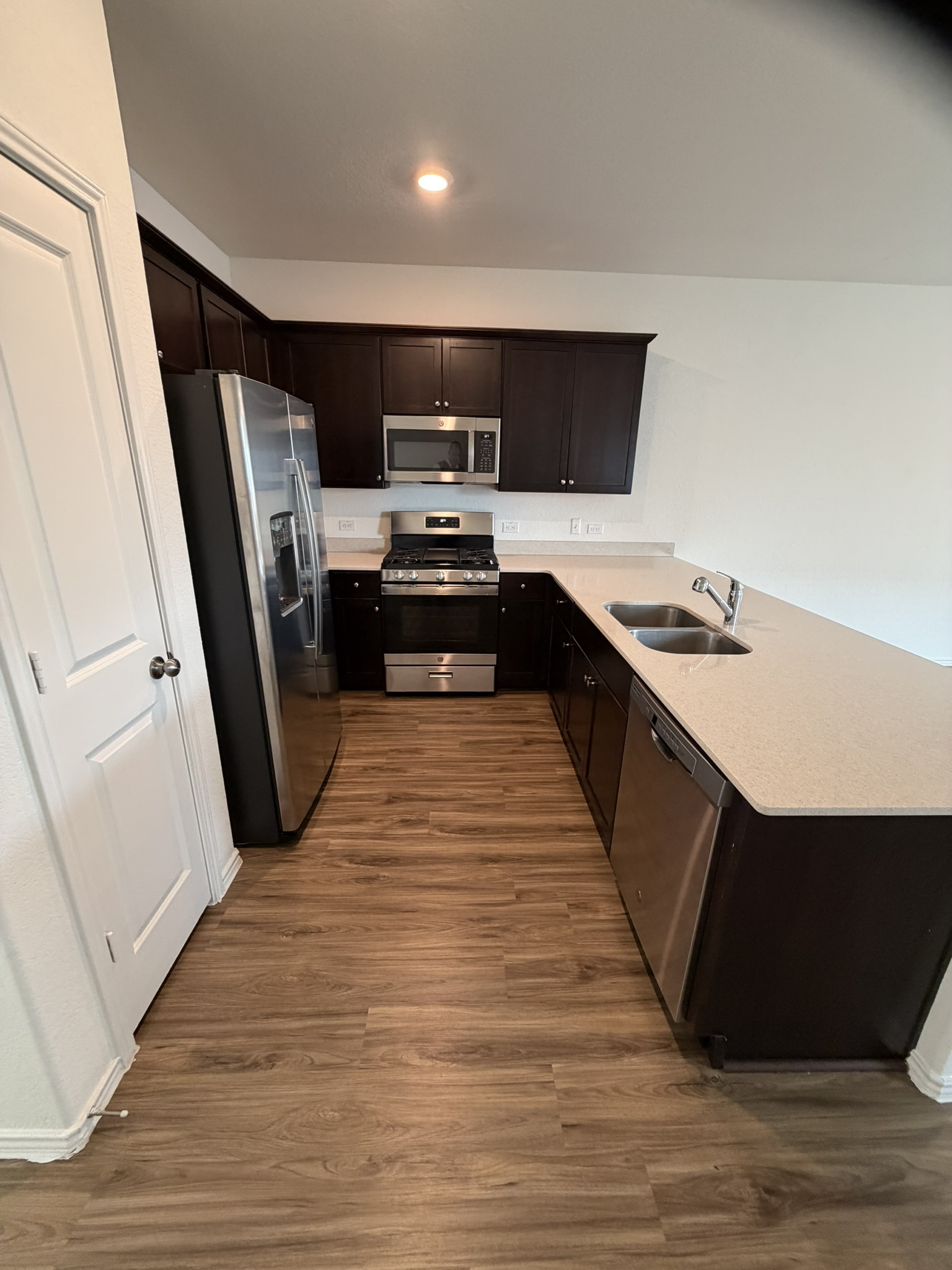 408 Buckners Street Georgetown, TX 78626 - Photo 9 of 15 a kitchen with stainless steel appliances a sink cabinets and wooden floor