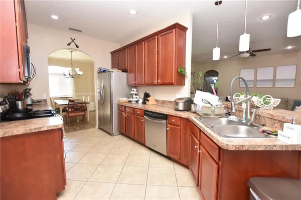 a kitchen with stainless steel appliances granite countertop a sink counter space cabinets and a stove