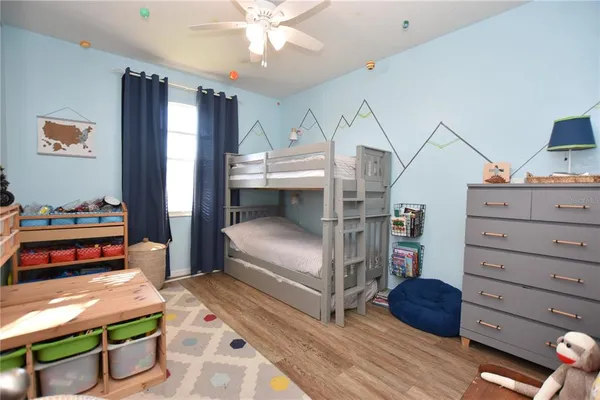a bedroom with furniture and a dresser