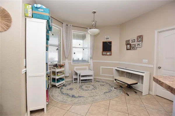 a living room with furniture a dining table and a rug