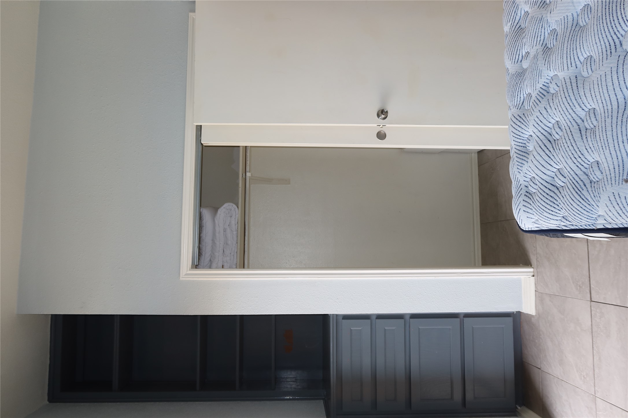2802 Nueces Street, Unit 306 Austin, TX 78705 - Photo 14 of 20 Built-in shelving unit with lower drawers, white sliding closet doors, and light-colored tile flooring