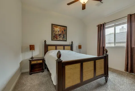 a bed sitting in a bedroom next to a window