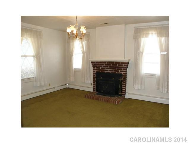 205 26th Street Southwest Hickory, NC 28602 - Photo 3 of 16 a room with a fireplace and chandelier