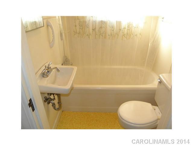 205 26th Street Southwest Hickory, NC 28602 - Photo 10 of 16 a bathroom with a sink a toilet and bathtub