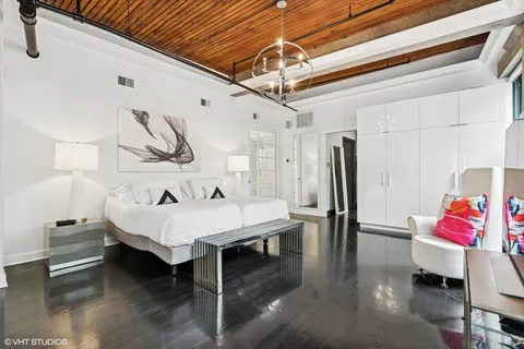 a bedroom with furniture and a flat screen tv