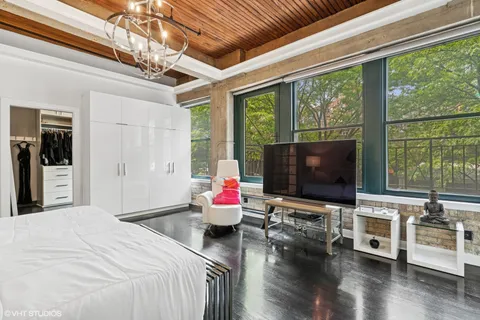 a large white bathroom with a granite countertop sink a mirror and a bathtub