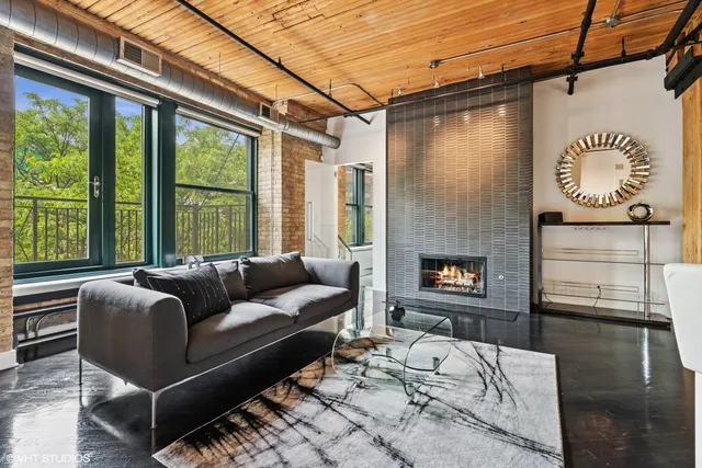 a kitchen with a sink and a stove top oven with wooden floor