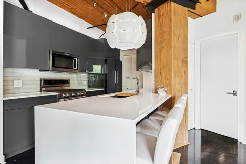 a kitchen with stainless steel appliances granite countertop a sink and stove top oven