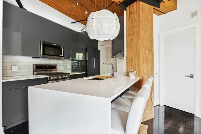 a kitchen with stainless steel appliances granite countertop a sink and stove top oven