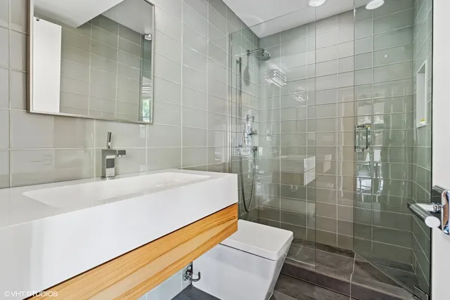 a view of a balcony with wooden floor and fence
