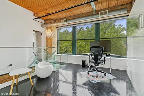 a view of a workspace with furniture and wooden floor