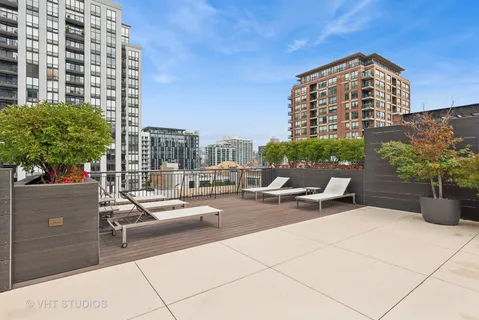 a view of a terrace with chairs and potted plants