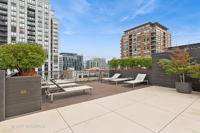 a view of a terrace with chairs and potted plants