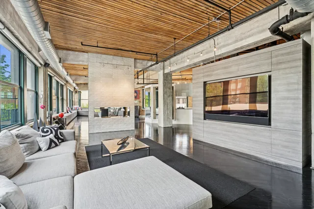 a living room with patio furniture and a large window