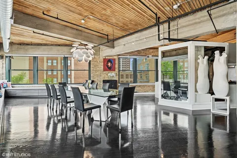 a dining room with furniture window and wooden floor
