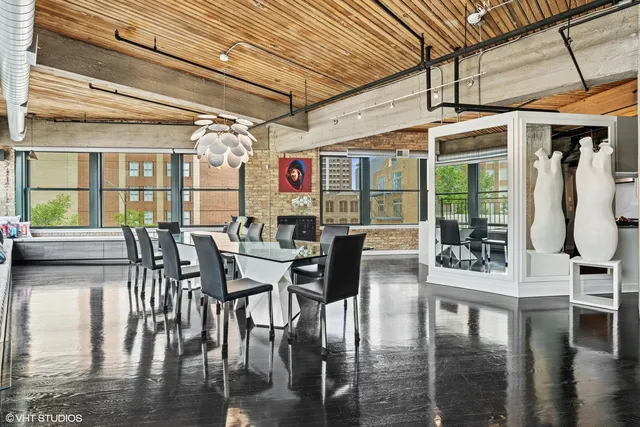 a dining room with furniture window and wooden floor