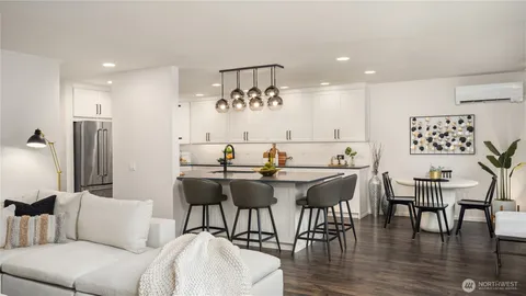 a living room with furniture and a floor to ceiling window