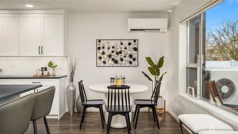 a living room with furniture a fireplace and a chandelier