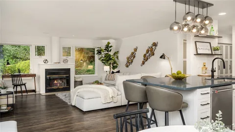 a kitchen with a table chairs and chandelier