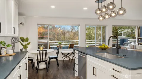 a kitchen with stainless steel appliances granite countertop a sink refrigerator and cabinets