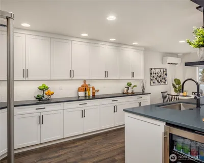 a bedroom with a bed a wall painting and a window