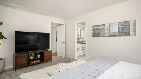 a bathroom with a granite countertop sink a mirror and shower