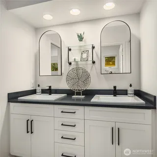 a bathroom with a granite countertop sink and a mirror