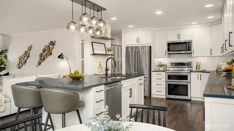 a living room with furniture a table and chairs