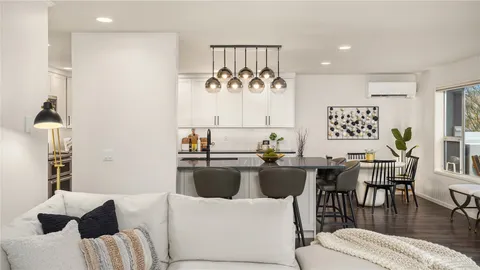 a living room with furniture fireplace and potted plants